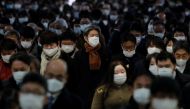 Commuters wearing protective face masks, amid the coronavirus disease (COVID-19) pandemic, make their way at a train station in Tokyo, Japan, January 17 2022. REUTERS/Kim Kyung-Hoon