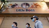 People stand in front of a temporarily closed pet shop after the government announced to euthanize around 2,000 hamsters in Hong Kong, China, January 18, 2022. Reuters/Tyrone Siu