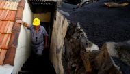 80-year-old Sabino Leal, a resident of Las Manchas, returns home for the first time since the eruption of the Cumbre Vieja volcano, on the Canary Island of La Palma, Spain, January 20, 2022. Picture taken January 20, 2022. REUTERS/Borja Suarez