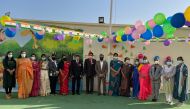 The management members, senior leadership team, and teachers of Olive International School after hoisting  the national flag.