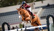 Cyrine Cherif guides her 11-year-old stallion Brennus Villelongue over a fence during ninth round of the Longines Hathab Qatar Equestrian Tour at the Qatar Equestrian Federation’s outdoor arena yesterday.
