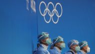 Medical personnel wearing personal protective equipment (PPE) sit rink-side at the Wukesong Arena for ice hockey games ahead of the Beijing 2022 Winter Olympics in Beijing, China, January 30, 2022. REUTERS/Brian Snyder