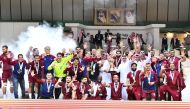 Qatar players and officials celebrate with the trophy after winning the Asian Men’s Handball Championship title in Dammam, yesterday.