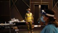 An Australian Defence Force member watches over a coronavirus disease (COVID-19) vaccination clinic at the Bankstown Sports Club as the city experiences an extended lockdown, in Sydney, Australia, August 3, 2021. REUTERS/Loren Elliott

