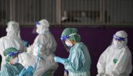 FILE PHOTO: Healthcare workers get ready to collect samples during proactive testing of migrant workers at their work place, amid the spread of the coronavirus disease (COVID-19) outbreak in Samut Sakhon province in Thailand, January 27, 2021. REUTERS/Chalinee Thirasupa


