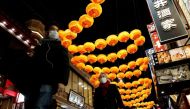 People wearing protective masks, amid the coronavirus disease (COVID-19) outbreak, walk past lantern decoration on Lunar New Year's Eve at China town in Yokohama, Kanagawa Prefecture, Japan, January 31, 2022. REUTERS/Kim Kyung-Hoon
