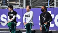 FILE PHOTO: Aston Martin's Sebastian Vettel and Mercedes' Lewis Hamilton take the knee before the race Pool via REUTERS/Andrej Isakovic/File Photo
