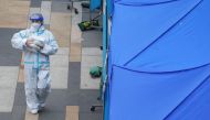 A medical worker walks past a makeshift testing centre for the coronavirus disease (COVID-19) following the outbreak, outside a shopping mall at Sha Tin district, in Hong Kong, China, February 7, 2022. REUTERS/Lam Yik
