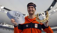 Gold Medallist Thomas Krol of the Netherlands celebrates during the flower ceremony. REUTERS/Susana Vera
