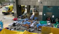 Patients wearing face masks lie in bed at a makeshift treatment area outside a hospital, following the Covid-19 outbreak in Hong Kong, China February 16, 2022. Reuters/Aleksander Solum/File Photo