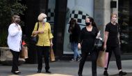 Shoppers walk through a retail district in the wake of coronavirus disease (COVID-19) lockdown restrictions being eased in Auckland, New Zealand, November 10, 2021. REUTERS/Fiona Goodall

