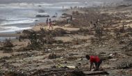 A boy searches among debris on the beach, in the aftermath of Cyclone Batsirai, in the town of Mananjary, Madagascar, February 8, 2022. REUTERS/Alkis Konstantinidis TPX IMAGES OF THE DAY/File Phot