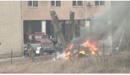 Uniformed people are seen throwing items into a fire outside intelligence building on the premises of the Ukrainian Defence Ministry's unit, in Kyiv, Ukraine February 24, 2022 in this screen grab taken from a video. REUTERS 
