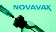A vial and sryinge are seen in front of a displayed Novavax logo in this illustration taken January 11, 2021. REUTERS/Dado Ruvic/Illustration/File Photo/File Photo