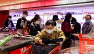 A customer wearing a mask buys fresh meat at a supermarket ahead of mass coronavirus disease (COVID-19) testing in Hong Kong, China March 1, 2022. REUTERS/Tyrone Siu