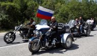FILE PHOTO: Russia's Prime Minister Vladimir Putin (2nd L) rides a Harley Davidson Lehman Trike as he arrives for a meeting with Russian and Ukrainian bikers at their camp near Sevastopol in Ukraine's Crimea, July 24, 2010. REUTERS/Sergei Karpukhin/File Photo
