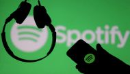 FILE PHOTO: A smartphone and a headset are seen in front of a screen projection of Spotify logo, in this picture illustration taken April 1, 2018. REUTERS/Dado Ruvic/Illustration/File Photo
