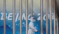 A worker with Personal Protective Equipment (PPE) walks at the Olympic Village, on the day that the International Paralympic Committee (IPC) confirmed that Russian and Belarusian athletes can no longer compete in the Beijing Paralympics, in Beijing, China, March 3, 2022. Reuters/Soe Zeya Tun