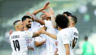 Al Sadd players celebrate after Abdelkarim Hassan scored their opening goal.