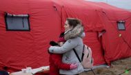 A woman hugs a child as they wait for transport after fleeing the Russian invasion of Ukraine, at a border crossing in Vysne Nemecke, Slovakia. Reuters/Lukasz Glowala