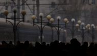 Silhouettes of people waiting on a platform for a train heading to Poland are seen as refugees flee Russia's invasion of Ukraine, in the train station in Lviv, Ukraine March 5, 2022. REUTERS/Kai Pfaffenbach