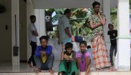 Rohingya refugees among the 114 fresh arrivals sitting in a temporary shelter in Bireuen, Aceh province, Indonesia, March 6, 2022. 