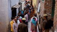 People stand in a queue to cast their votes at a polling station during the last phase of state assembly election in Varanasi in the northern state of Uttar Pradesh, India, March 7, 2022. Reuters/Adnan Abidi