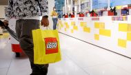 A customer carries a bag while shopping in the 5th Avenue Lego store in New York City, U.S., September 28, 2021. REUTERS/Brendan McDermid/File Photo/File Photo