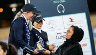 Qatar’s top dressage rider Wejdan Majed Al Malki presents a trophy to Jessica Waldon, who won the Medium Level 1 event in the final round of the Longines Hathab Dressage Tour yesterday.