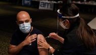 Nurse immuniser Kelie Lee administers the AstraZeneca vaccine to a patient at a coronavirus disease (COVID-19) vaccination clinic at the Bankstown Sports Club during a lockdown to curb an outbreak of cases in Sydney, Australia, August 25, 2021. REUTERS/Loren Elliott

