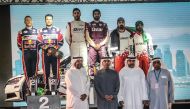 Qatar's Khaled Al Suwaidi and Hugo Magalhaes with other podium winners and officials at the end of the Kuwait International Rally, yesterday. 