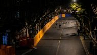 People pass by barriers that have been built to separate residential buildings from a street, amid the coronavirus disease (COVID-19) pandemic, in Shanghai, China March 22, 2022. REUTERS/Aly Song
