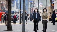 FILE PHOTO: Women wearing masks walk in a shopping district amid the coronavirus disease (COVID-19) pandemic in SEOUL, South Korea, March 16, 2022. REUTERS/Heo Ran/File Photo

