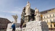 Volunteers cover the monuments of Princess Olga, Apostle Andrew and Saints Cyril and Methodius with sand bags for protection, as Russia's invasion of Ukraine continues, in Kyiv, Ukraine March 28, 2022. REUTERS/Vladyslav Musiienko/File Photo

