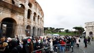 People wait in line before entering the Colosseum as Italy begins to ease some of the coronavirus disease (COVID-19) restrictions, lifting the obligation to show a health pass to sit at outdoor restaurants, access museums and other activities in Rome, Italy, April 1, 2022. REUTERS/Guglielmo Mangiapane



