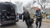 Volunteers prepare to put the body of a civilian, who according to residents was killed by Russian soldiers, in a van carrying body bags, amid Russia's invasion on Ukraine, in Bucha, in Kyiv region, Ukraine, April 3, 2022. REUTERS/Stringer
