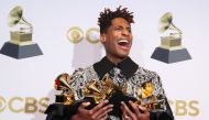Jon Batiste poses with their Grammys for Best American Roots Performance for 