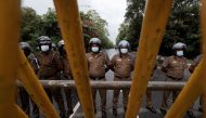 Sri Lanka police officers stand guard on a road leading to the parliament building, after the government of President Gotabaya Rajapaksa lost its majority, amid the country's economic crisis, in Colombo, Sri Lanka, April 5, 2022. REUTERS/Dinuka Liyanawatte

