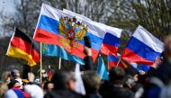 People hold Russian flags as pro-Russia supporters gather to take part in a motorcade in Hanover, Germany, April 10, 2022. REUTERS/Fabian Bimmer
