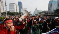 Students take part in a protest against proposals floated by some ministers to extend Indonesian President Joko Widodo's term and postpone the 2024 election, outside the National Monument (Monas) complex in Jakarta, Indonesia April 11, 2022. Reuters/Willy Kurniawan 