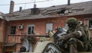 Service members of pro-Russian troops drive an armoured vehicle during Ukraine-Russia conflict in the southern port city of Mariupol, Ukraine April 11, 2022. Reuters/Chingis Kondarov 
