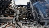 Emergency workers remove debris of a building destroyed in the course of the Ukraine-Russia conflict, in the southern port city of Mariupol, Ukraine April 10, 2022. REUTERS/Alexander Ermochenko

