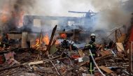 A firefighter holds a hose next to a burning building, following a missile attack near the Kharkiv International Airport, as Russia's attack on Ukraine continues, in Kharkiv, Ukraine, April 12, 2022. Picture taken April 12, 2022. REUTERS/Alkis Konstantinidis