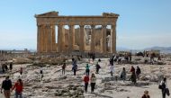 People visit the ancient Parthenon Temple atop the Acropolis hill archaeological site in Athens, Greece, February 26, 2022. REUTERS/Louiza Vradi/File Photo
