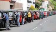 Drivers push their three-wheelers while waiting in a line to buy petrol at a Ceylon Ceypetco fuel station on a main road, amid the country's economic crisis in Colombo, Sri Lanka, April 12, 2022. REUTERS/Dinuka Liyanawatte/File Photo
