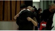 People hug in the arrivals area at the Auckland Airport, as Australians started arriving after the country opened its borders to travellers from its neighbouring nation for the first time since mid-2021, in Auckland, New Zealand, April 13, 2022 in this still image taken from a video. TVNZ/Handout via REUTERS