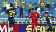 Al Duhail's Edmilson Junior (centre) in action against Pakhtakor FC's players yesterday. PIC: AFC