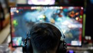 A man plays online game on a computer at an internet cafe in Beijing, China August 31, 2021. REUTERS/Florence Lo

