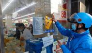 A delivery worker picks up a medicine order from a pharmacy in Huangpu district, amid the coronavirus disease (COVID-19) outbreak in Shanghai, China April 17, 2022. China Daily via Reuters