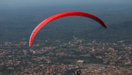 A paraglider flies with a passenger during the annual Easter paragliding festival in Kwahu-Atibie, Ghana April 15, 2022. Picture taken April 15, 2022. REUTERS/Francis Kokoroko